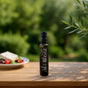 EVGE extra virgin olive oil 250 ml dark bottle on wooden table with olive branches